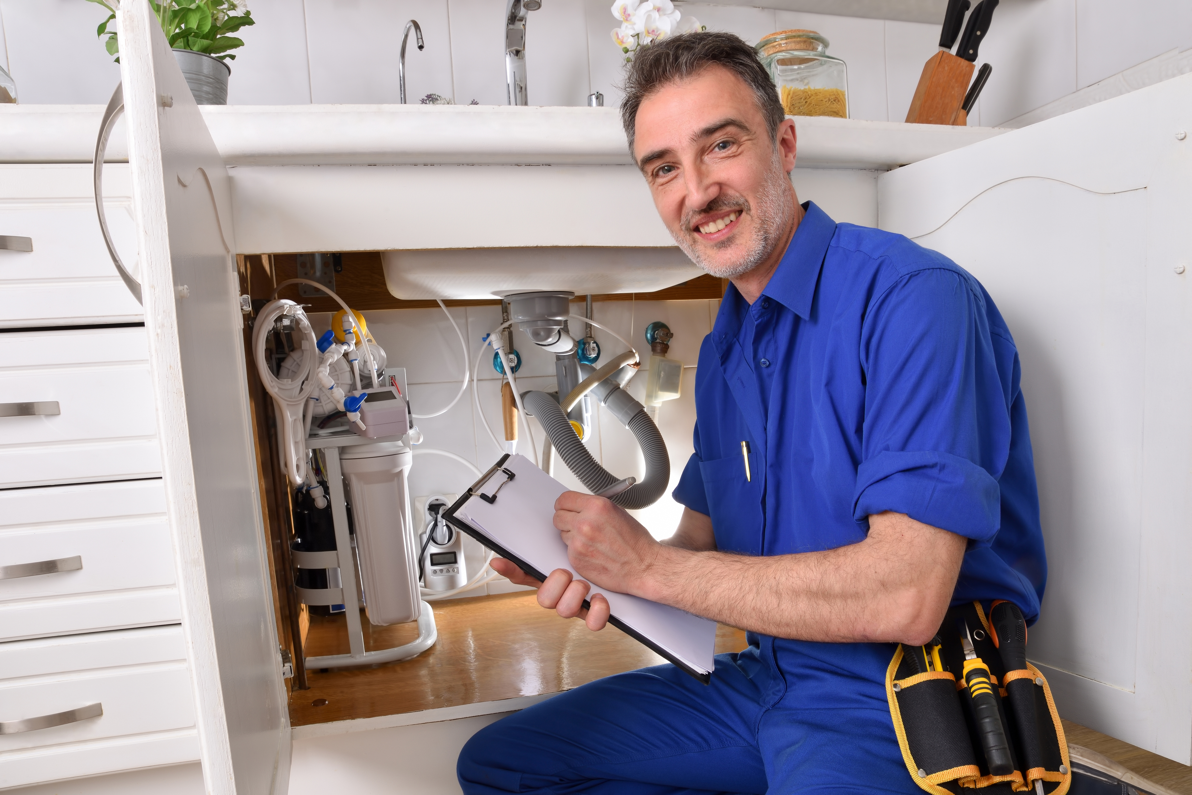 PHC0423_plumber reviewing kitchen sink repairs.jpg