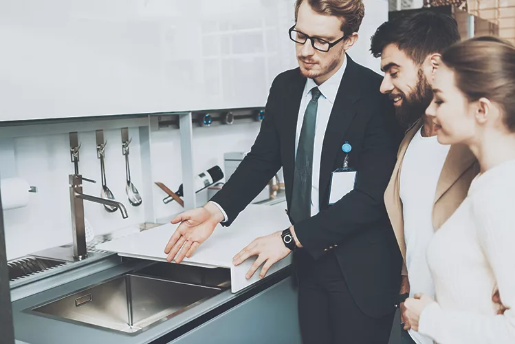 TW0723_showroom consultant with customers.jpg