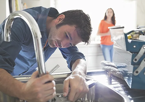 TW0726_young plumber fixing sink.jpg