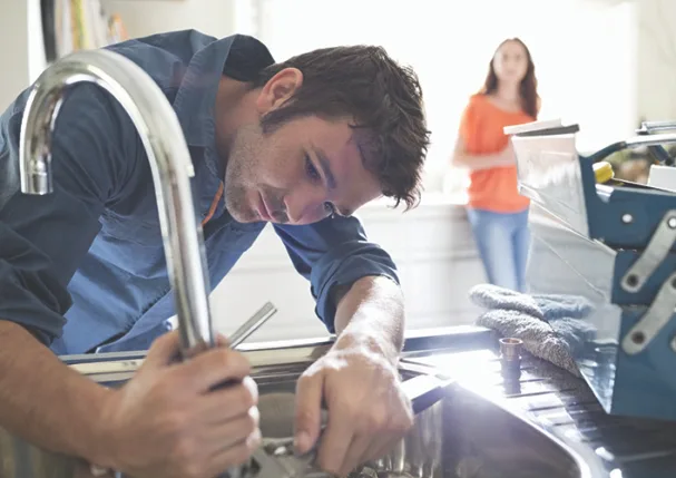 TW0726_young plumber fixing sink.jpg
