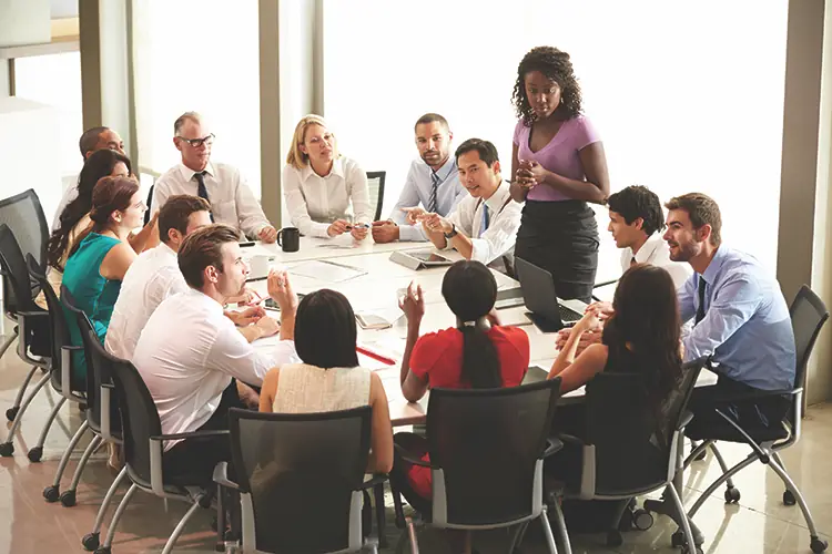 TW0726_businesswomen speaking to colleagues.jpg